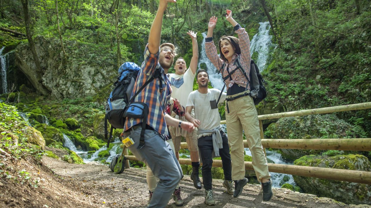Group of friends having fun and taking selfies in nature